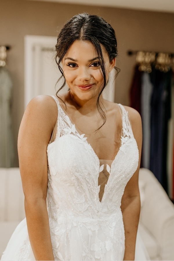 Photo of the smiling model wearing a bridal gown